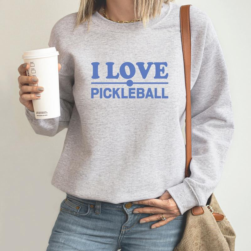 Cozy unisex sweatshirt with ‘I Love Pickleball’ text, perfect for pickleball fans and players